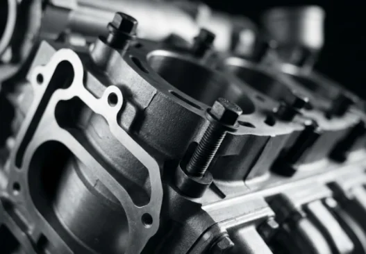 Close-up of engine components with bolts and gaskets.